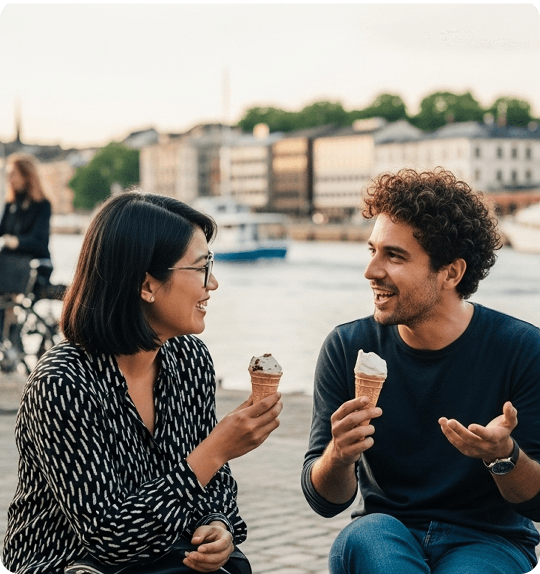 Three friends sitting together on a waterfront bench in Gothenburg, speaking Swedish and laughing as they share ice cream.