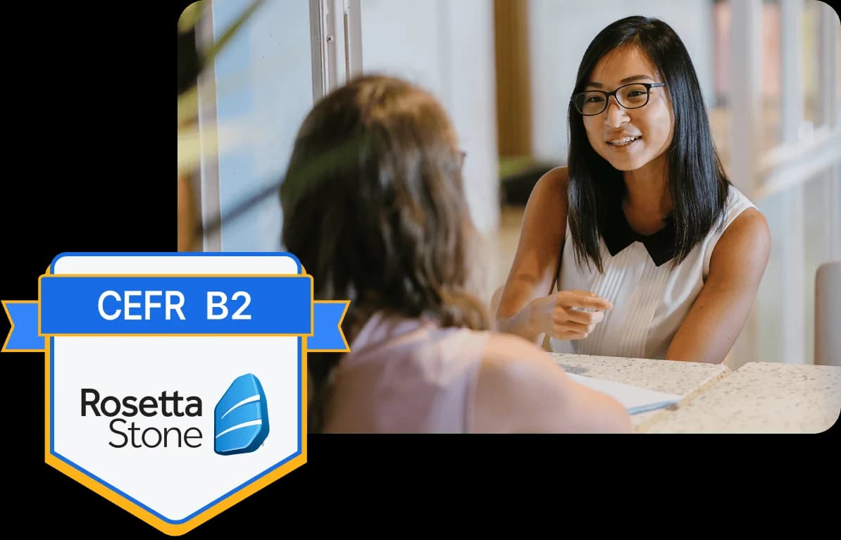 Two girls talking next to a Rosetta Stone certificate badge image.