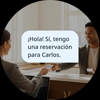 Two people having a conversation, with a speech bubble showing the Spanish phrase '¡Hola! Sí, tengo una reservación para Carlos,' illustrating a real-life dialogue mission.