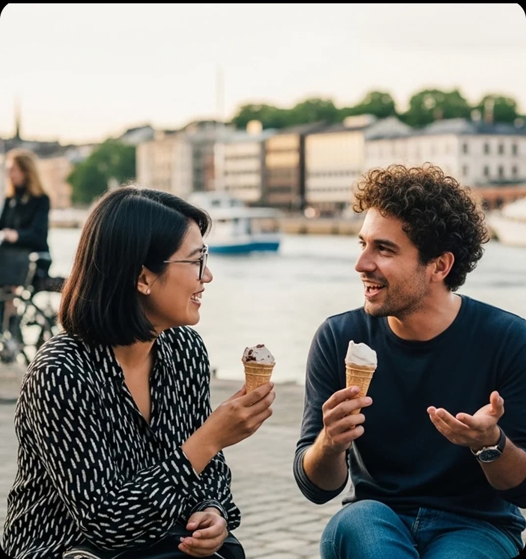 Three friends sitting together on a waterfront bench in Gothenburg, speaking Swedish and laughing as they share ice cream.