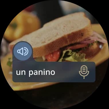 A close-up photo of a sandwich with the Italian label 'un panino' overlaid, demonstrating real-world object recognition in a language lesson.