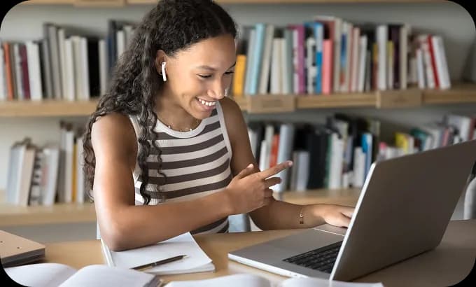 Woman participating in an online tutoring session from her home office, using her laptop